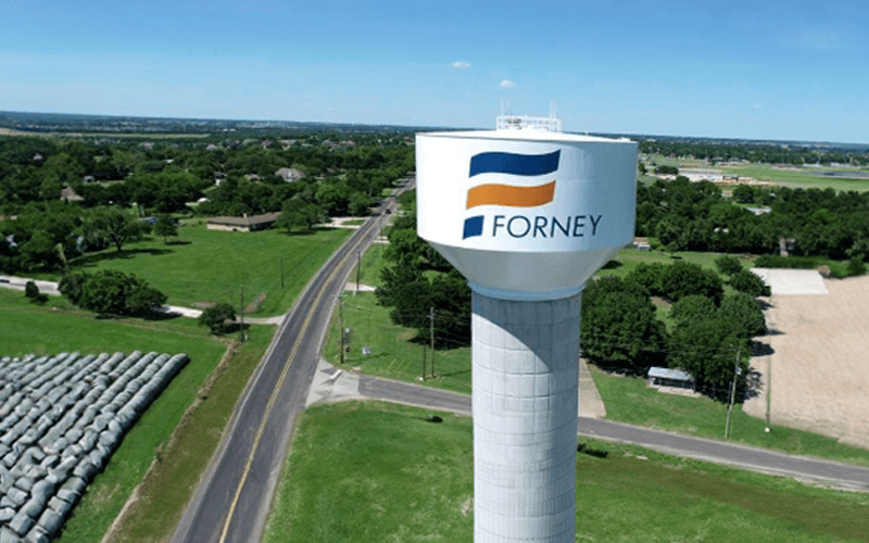 Water tower with 'Forney, Texas' displayed, promoting sell junk cars in Forney, Texas