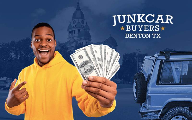 Young man showing cash in his hand, next to a junk car, with the city of Denton in the background