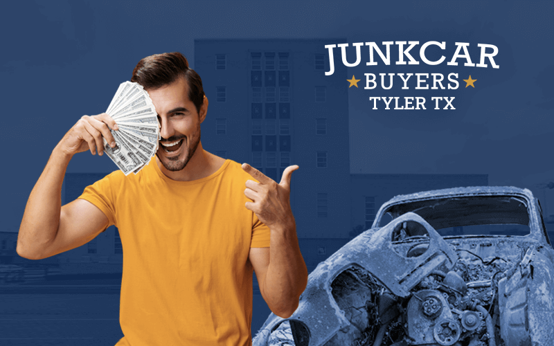 Young man showing cash in his hand, next to a junk car, with Tyler City in the background